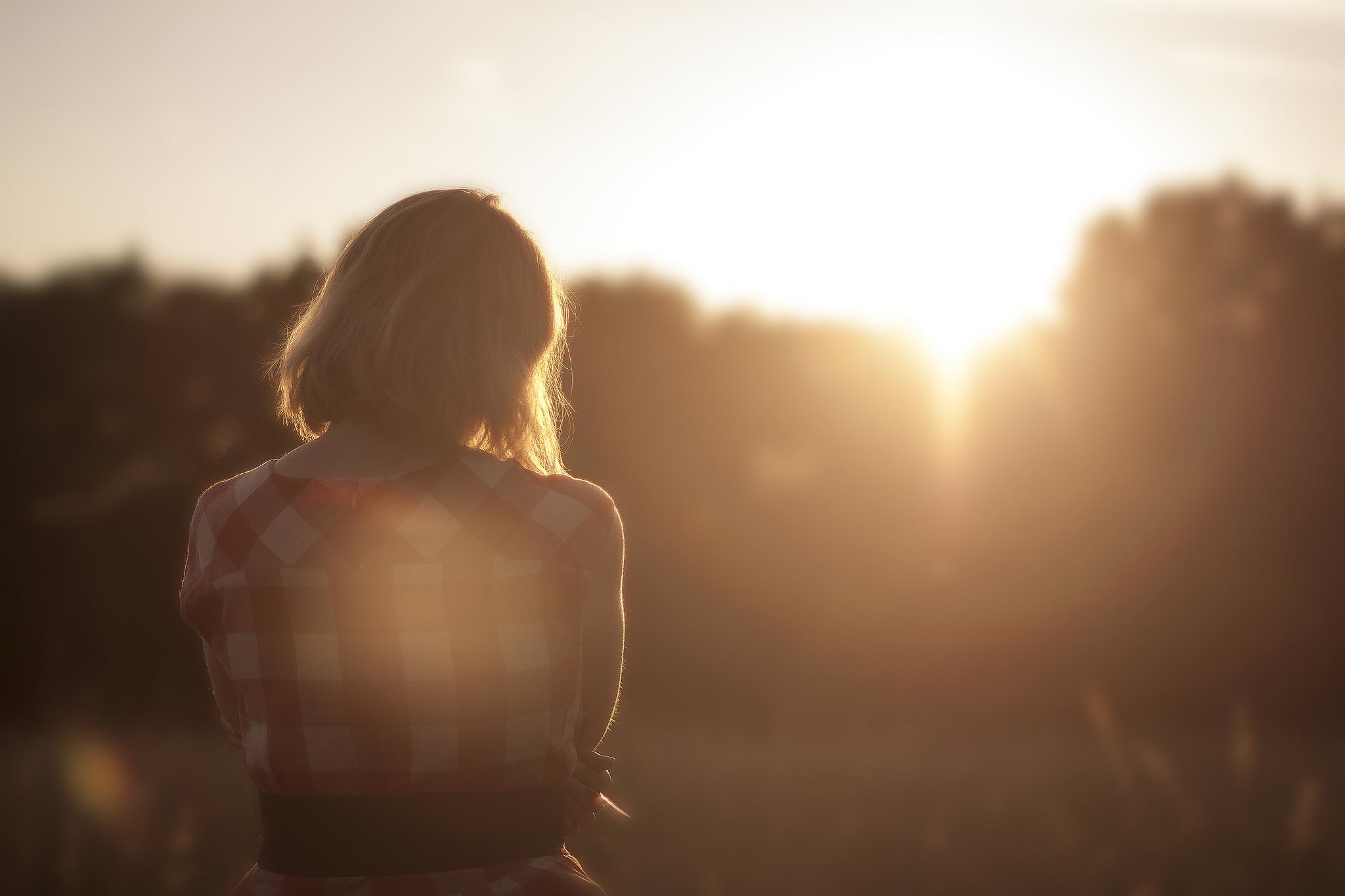 A person standing in warm dawn light